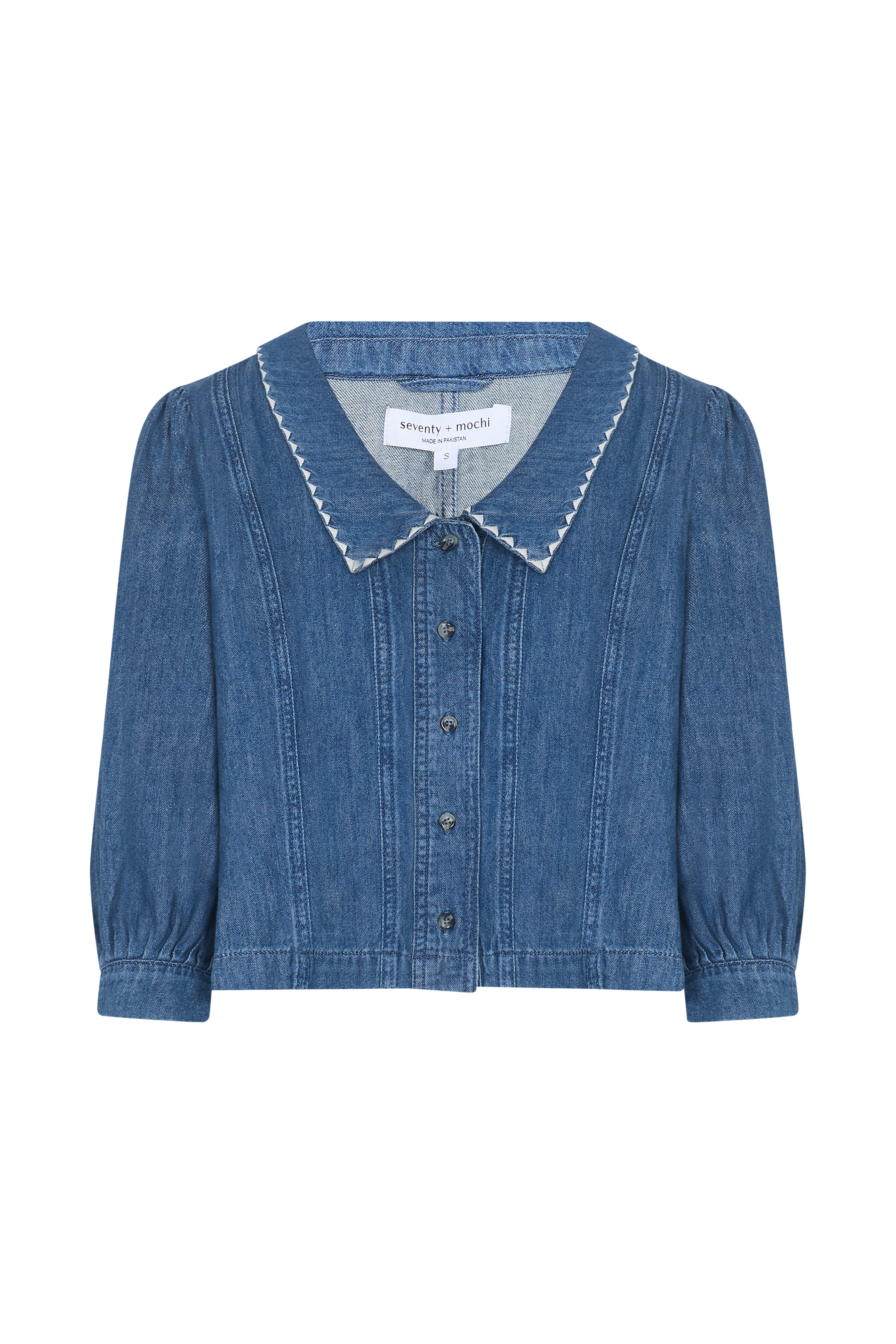 Blue denim button up top with an oversized collar on a white background