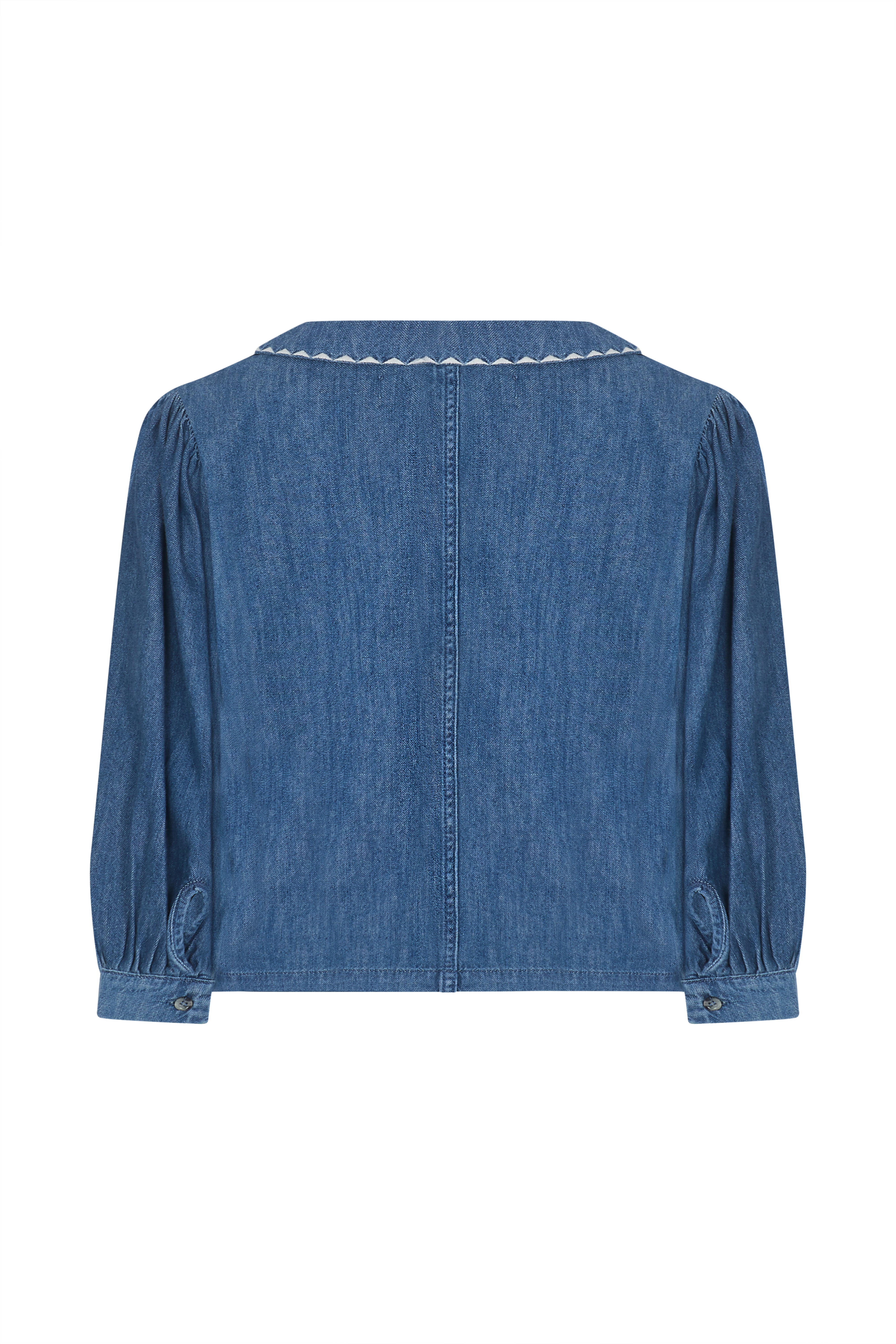 Back of a blue denim button up top with an oversized collar on a white background